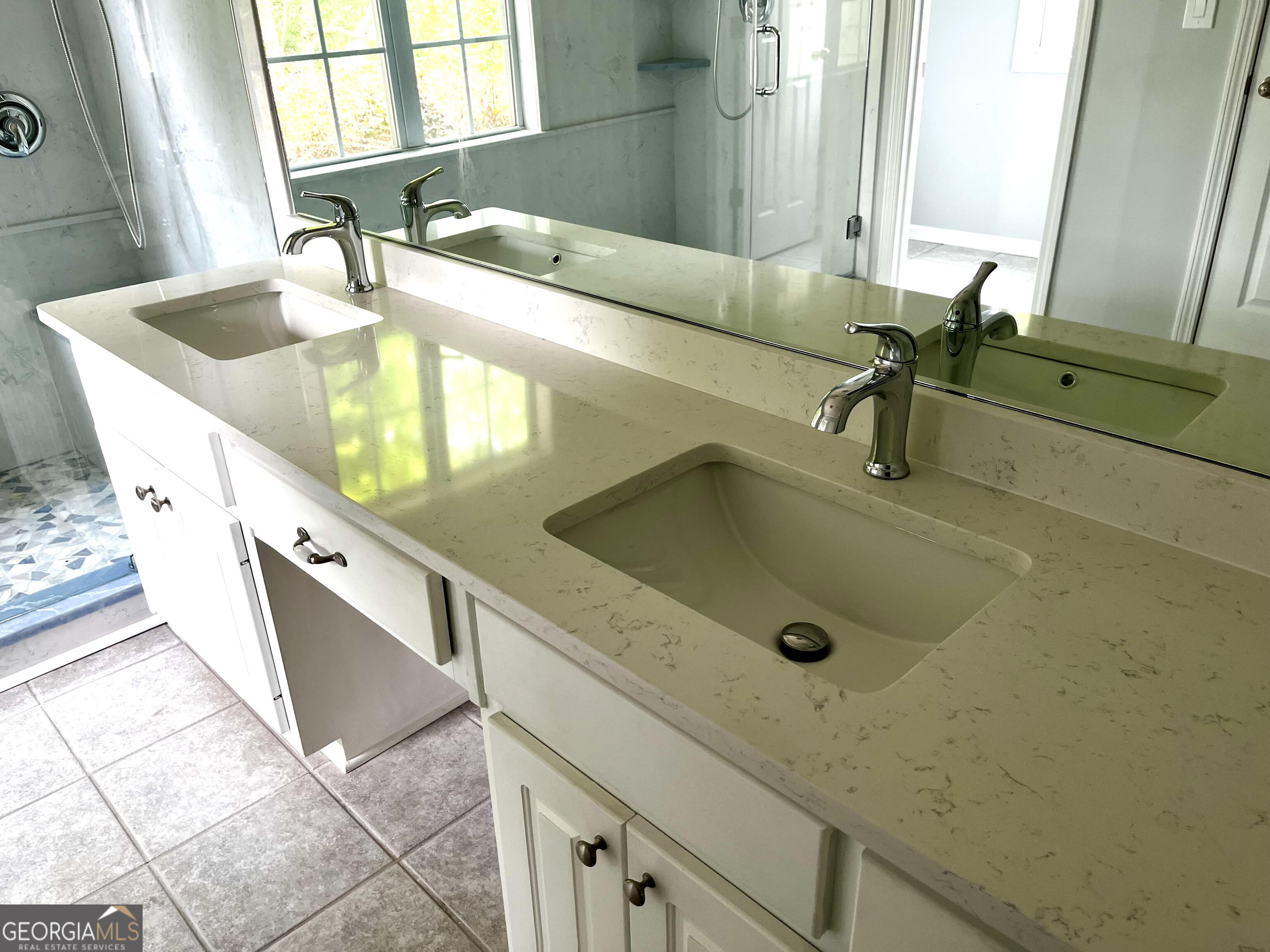 779 Appian Way Statham, GA 30666 - Photo 13 of 29 a bathroom with a double vanity sink a mirror and