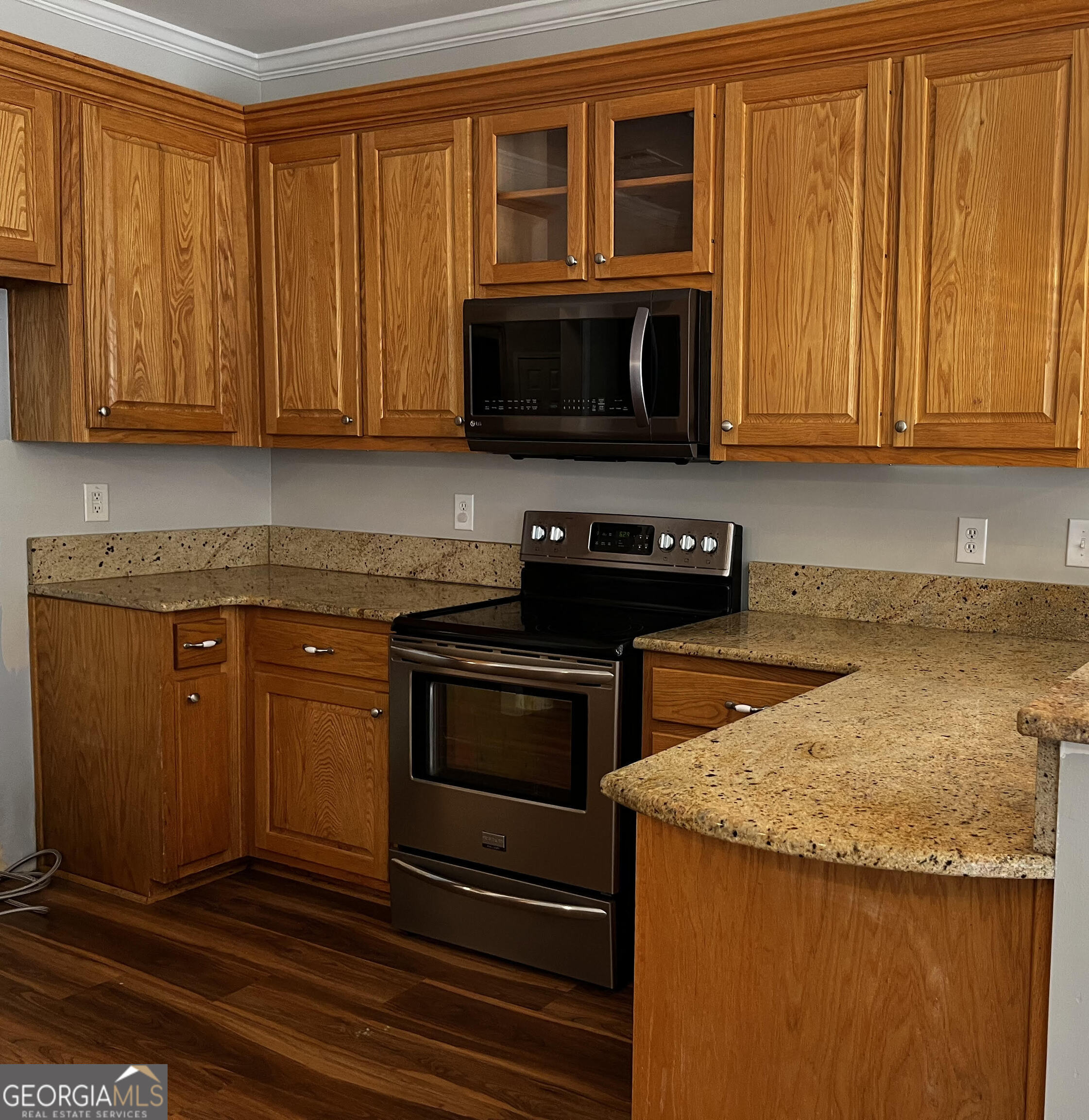 779 Appian Way Statham, GA 30666 - Photo 9 of 29 a kitchen with granite countertop wood cabinets stainless steel appliances and a window