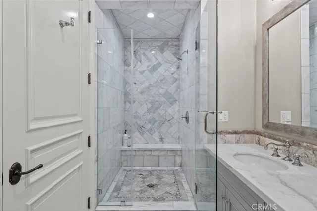 a utility room with stainless steel appliances white cabinets and a sink