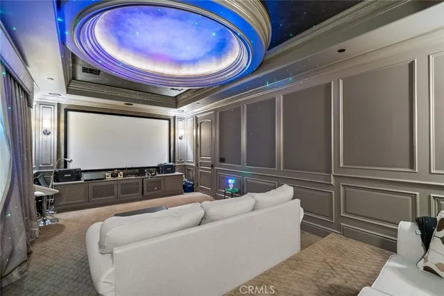 a kitchen with stainless steel appliances granite countertop a stove a sink dishwasher and white cabinets with wooden floor