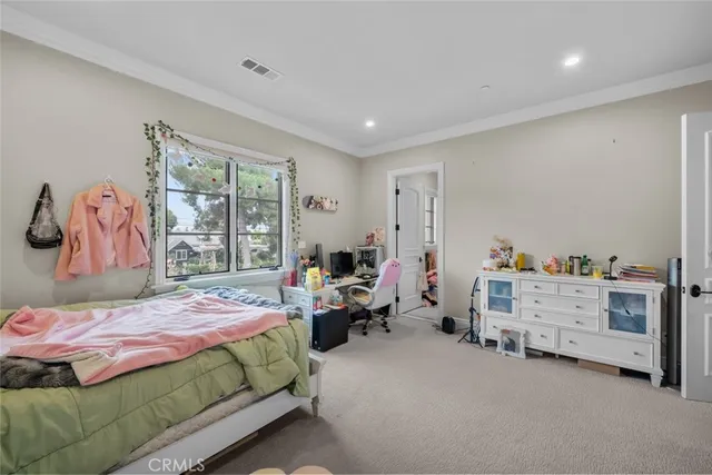 a view of a white house with a yard table and chairs