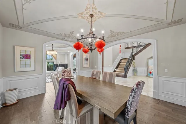 a living room with lots of furniture and chandelier