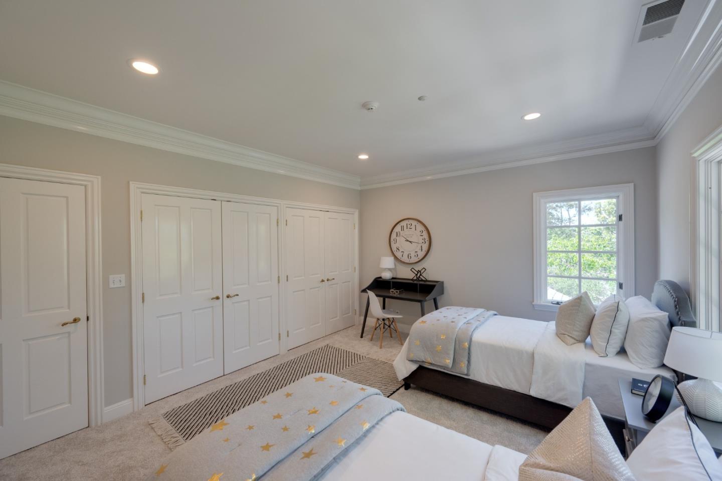 1230 Avondale Road Hillsborough, CA 94010 - Photo 35 of 73 a bedroom with a bed a chandelier and a window
