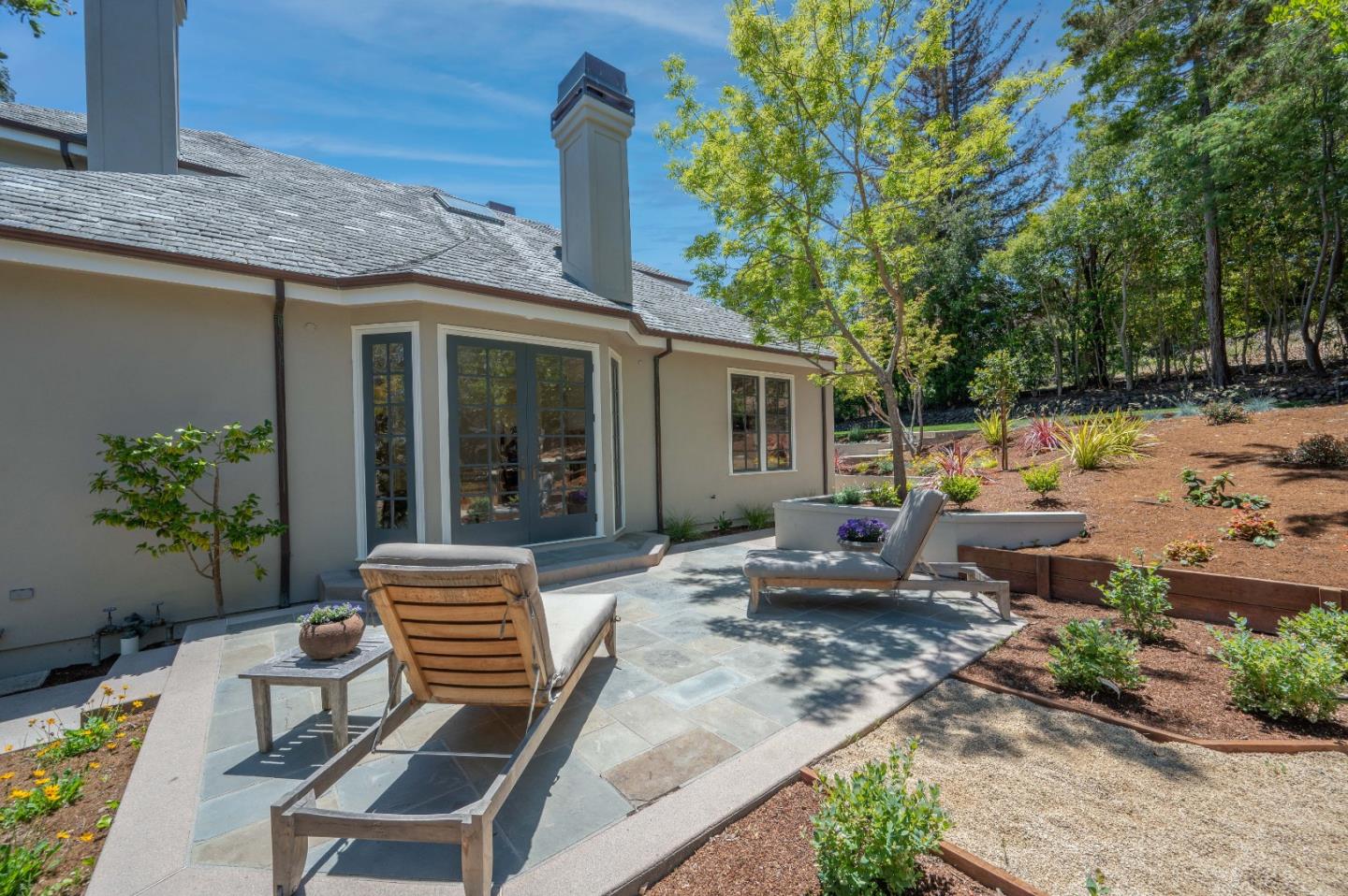 1230 Avondale Road Hillsborough, CA 94010 - Photo 63 of 73 a view of a patio with table and chairs potted plants and large tree