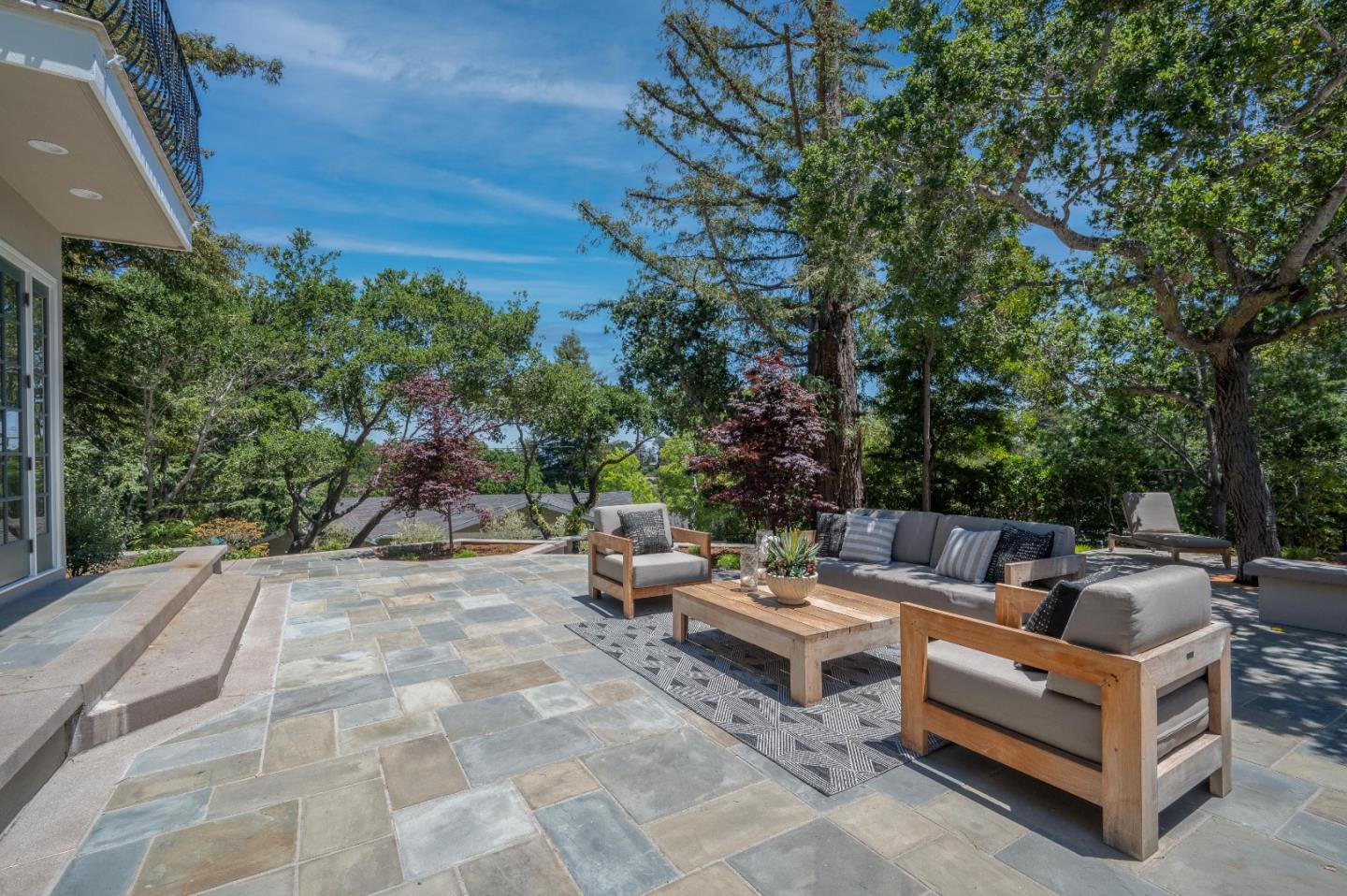 1230 Avondale Road Hillsborough, CA 94010 - Photo 68 of 73 a view of a patio with couches and chairs under an umbrella