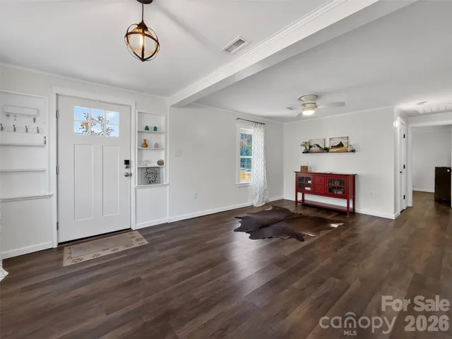 a view of empty room with wooden floor