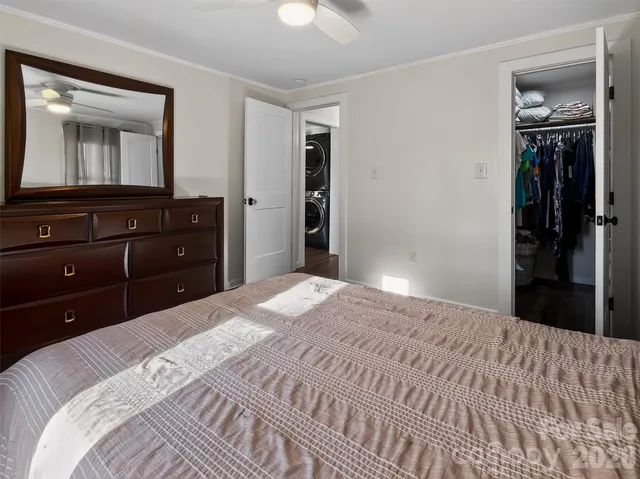 a bedroom with a bed and a mirror on dresser