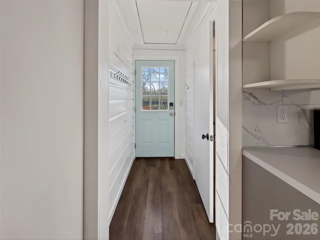 a view of a hallway with wooden floor