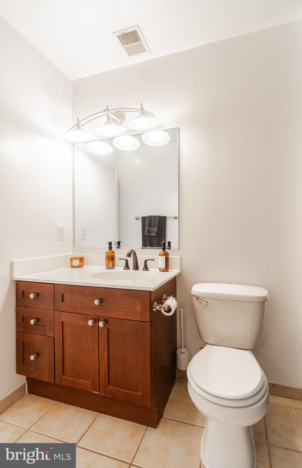 2120 Vermont Avenue Northwest, Unit 312 Washington, DC 20001 - Photo 12 of 16 a bathroom with a toilet sink and mirror