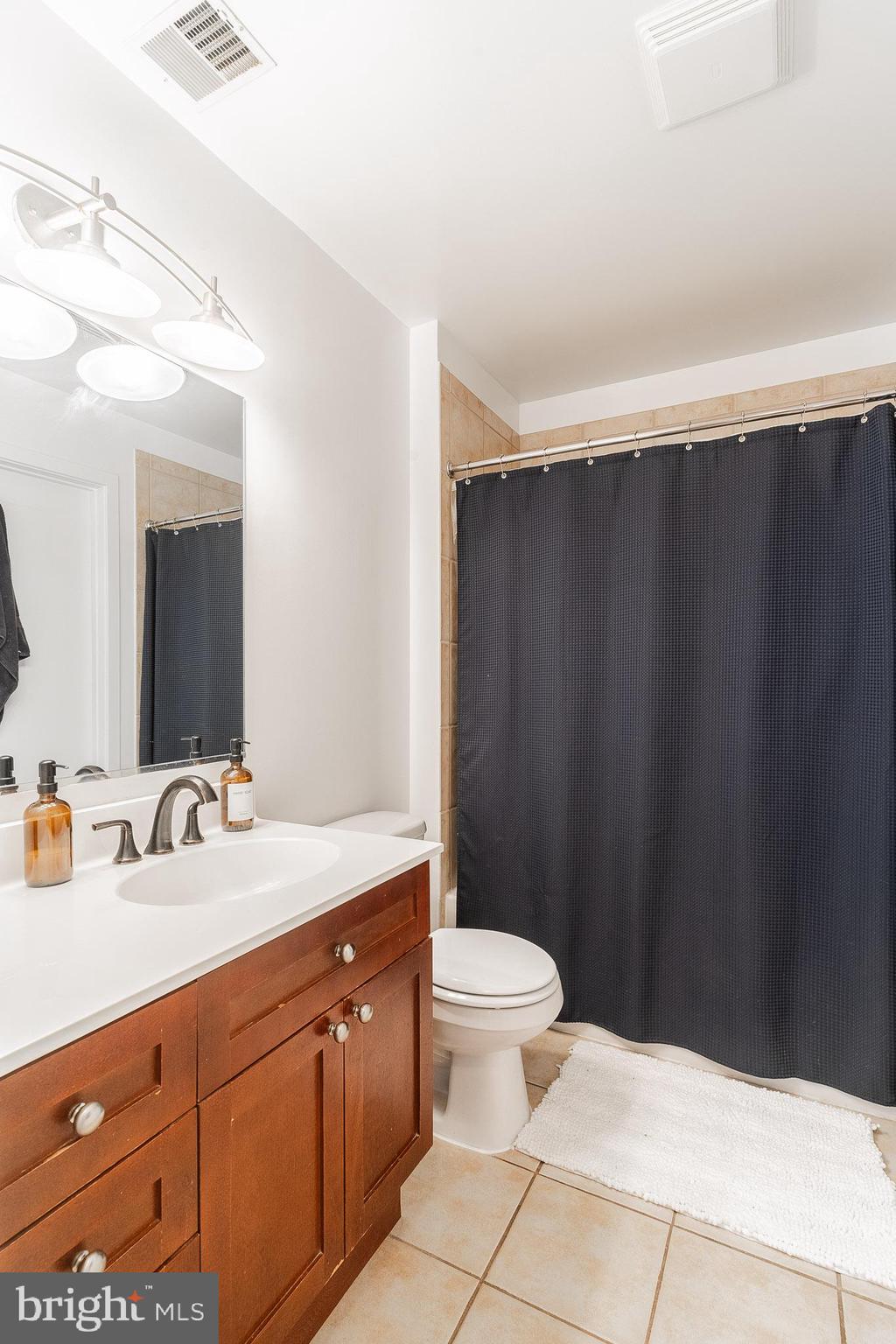 2120 Vermont Avenue Northwest, Unit 312 Washington, DC 20001 - Photo 13 of 16 a bathroom with a sink and a mirror