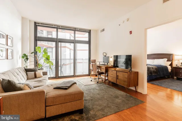 a living room with furniture and large windows