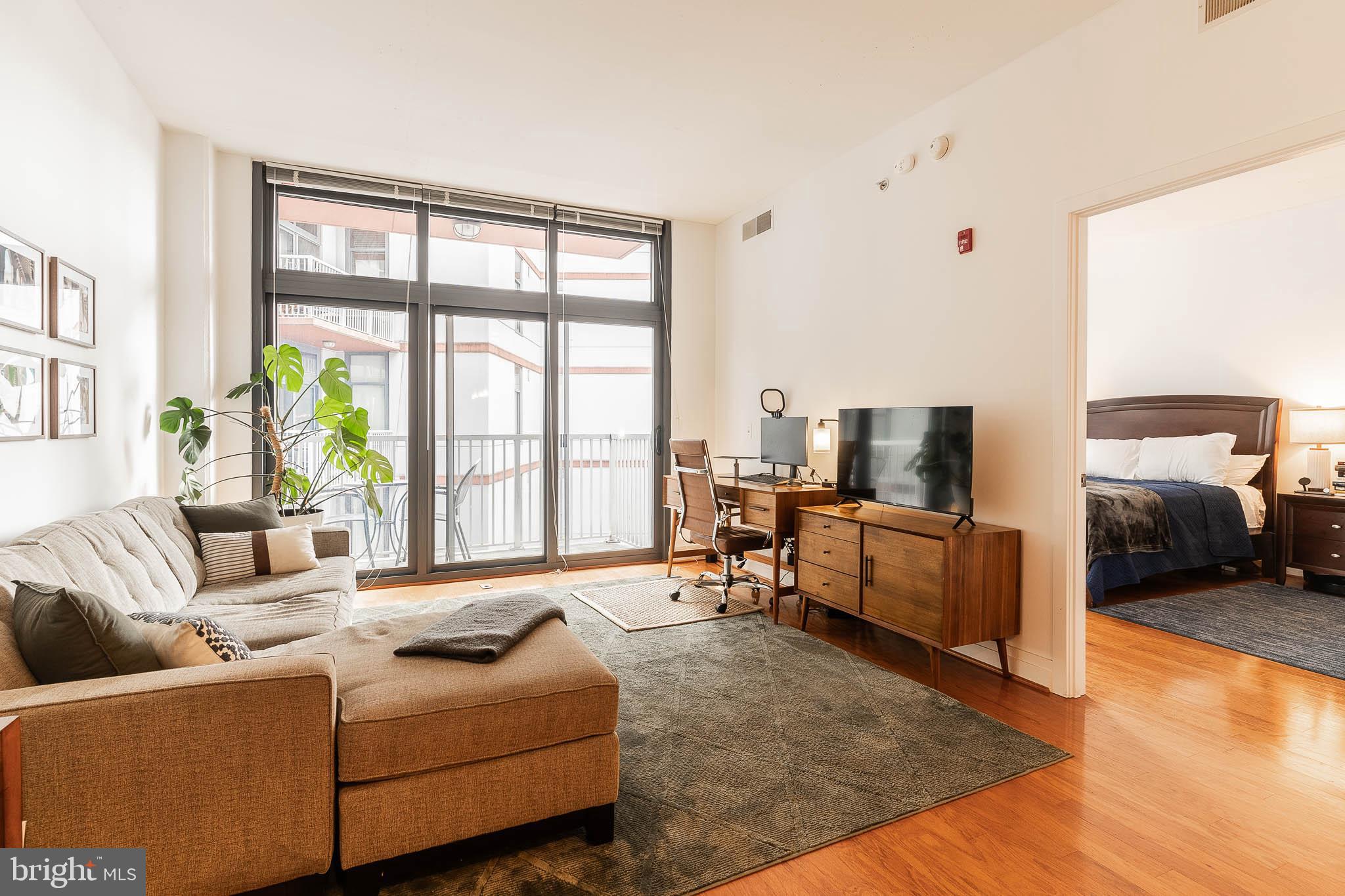 2120 Vermont Avenue Northwest, Unit 312 Washington, DC 20001 - Photo 5 of 16 a living room with furniture and large windows