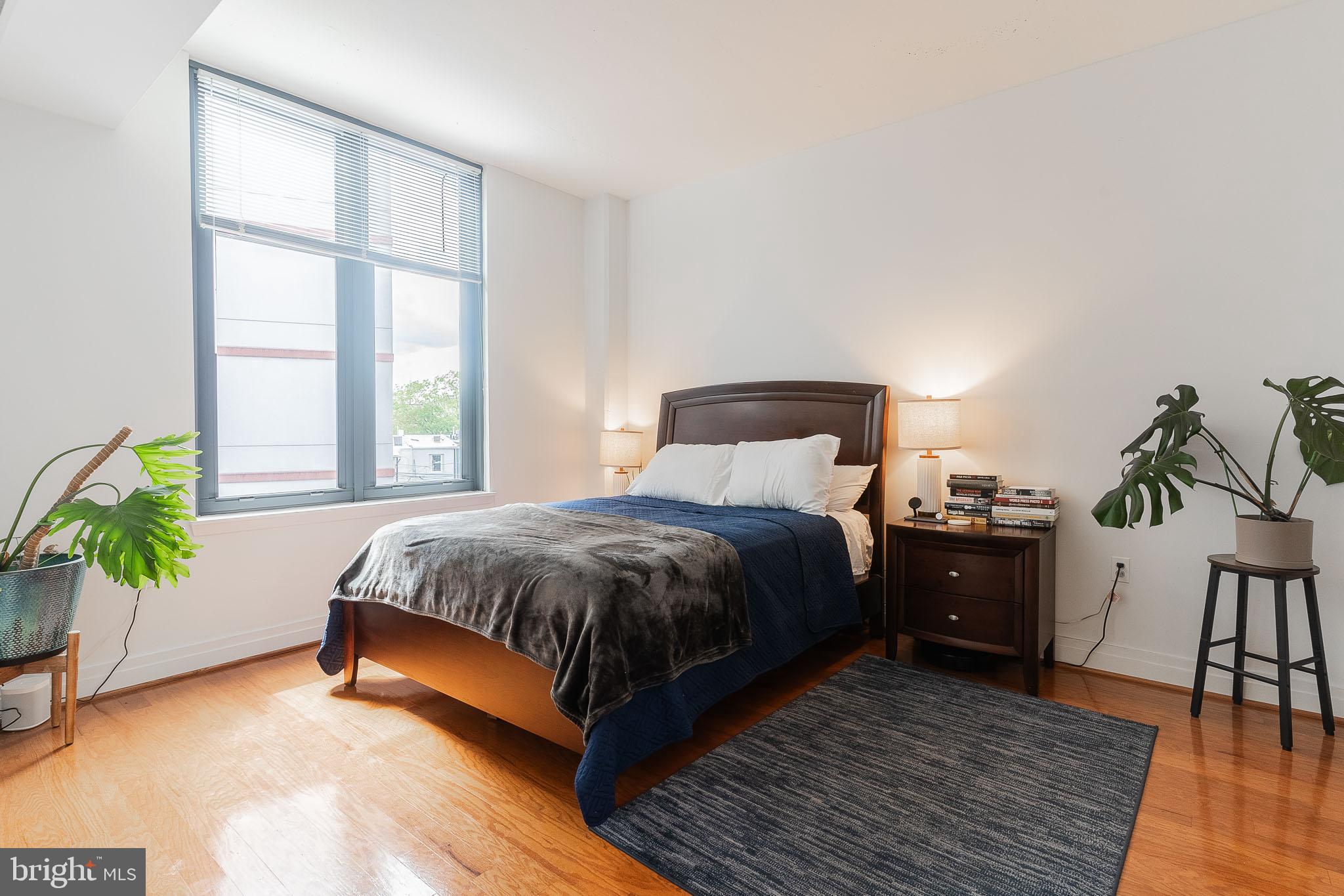 2120 Vermont Avenue Northwest, Unit 312 Washington, DC 20001 - Photo 8 of 16 a bedroom with a bed table and a window