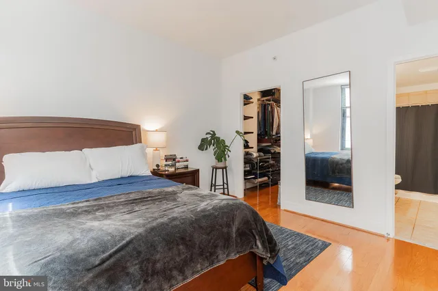 a bedroom with a bed and a television