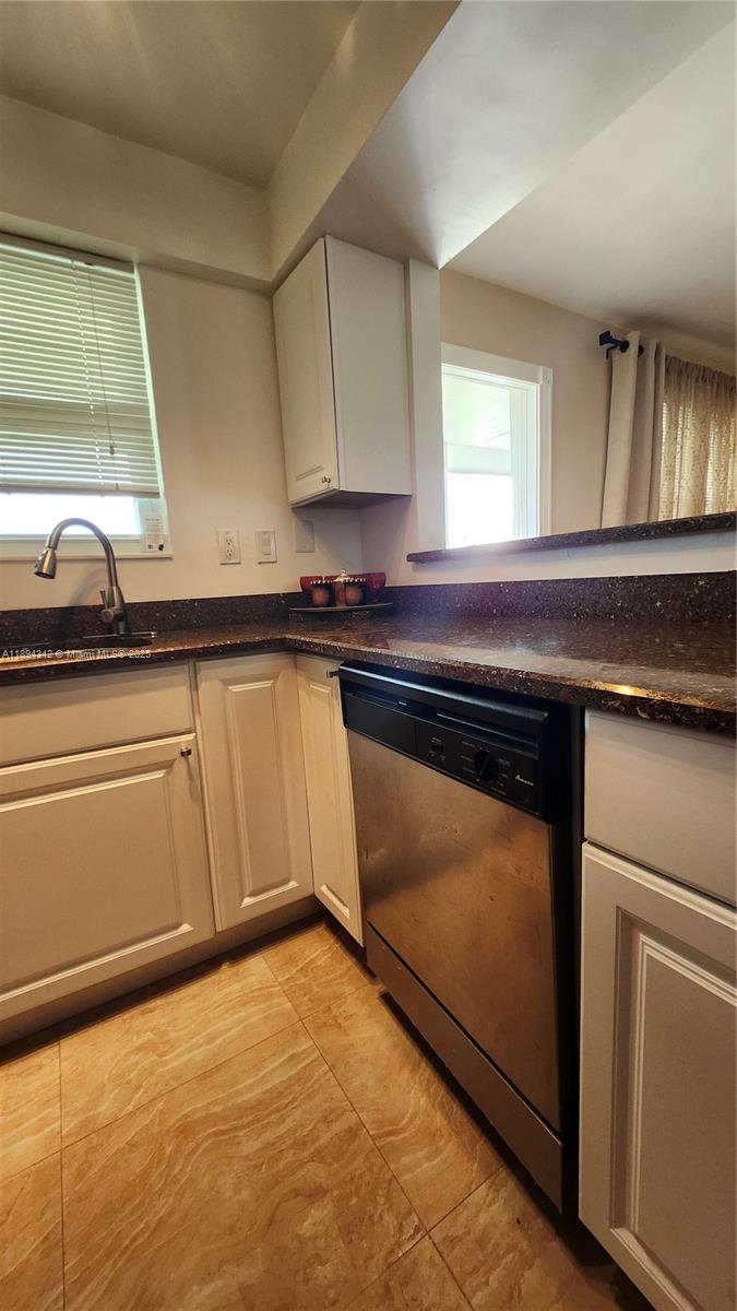 20 Southeast 13th Street, Unit C4 Boca Raton, FL 33432 - Photo 3 of 35 a kitchen with stainless steel appliances granite countertop a stove a sink and a microwave