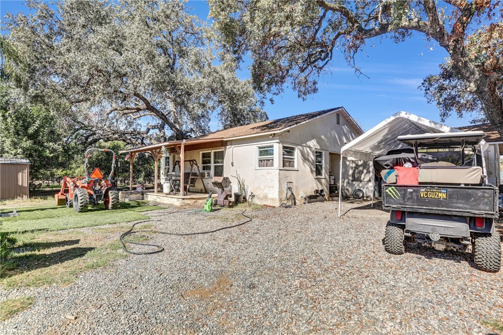 31030 Valley Center Road Valley Center, CA 92082 - Photo 8 of 20 a view of a house with a patio and a yard