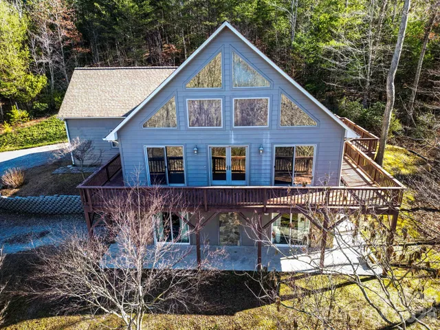 a front view of a house with yard and trees
