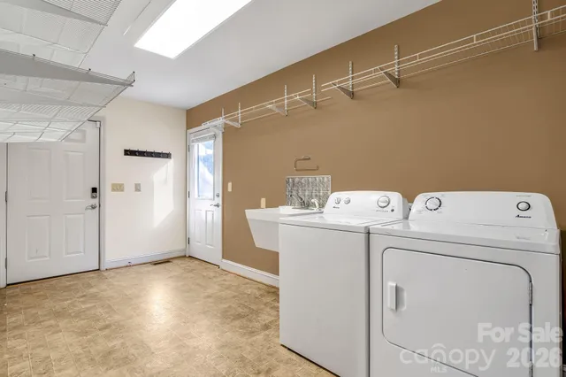 a bathroom with a sink vanity mirror toilet and bathtub