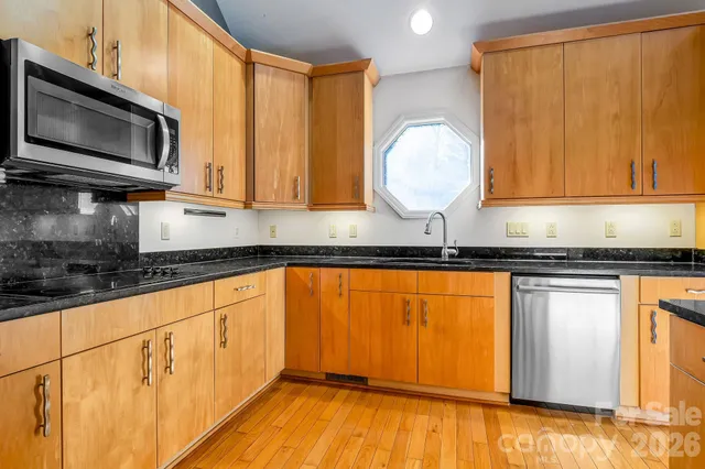 a view of a room with wooden floor