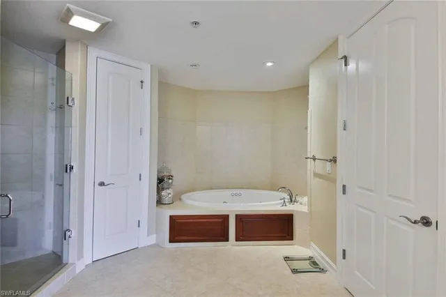 a bathroom with a tub a sink and a shower