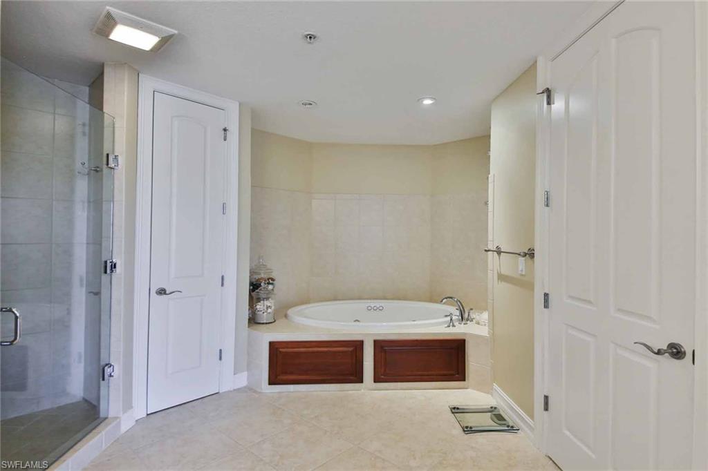 600 5th Avenue South, Unit A212 Naples, FL 34102 - Photo 15 of 21 a bathroom with a tub a sink and a shower