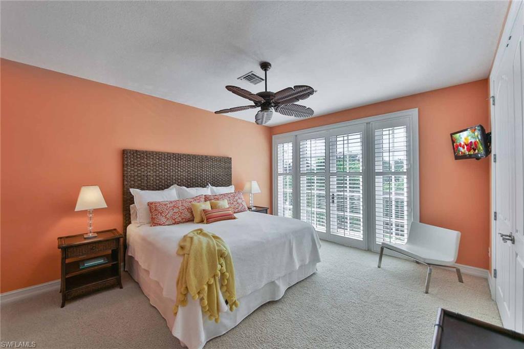 600 5th Avenue South, Unit A212 Naples, FL 34102 - Photo 16 of 21 a bedroom with a bed and a large window