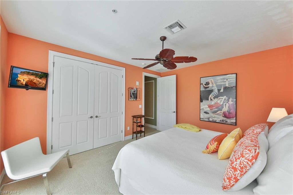 600 5th Avenue South, Unit A212 Naples, FL 34102 - Photo 17 of 21 a bedroom with a bed and a chair