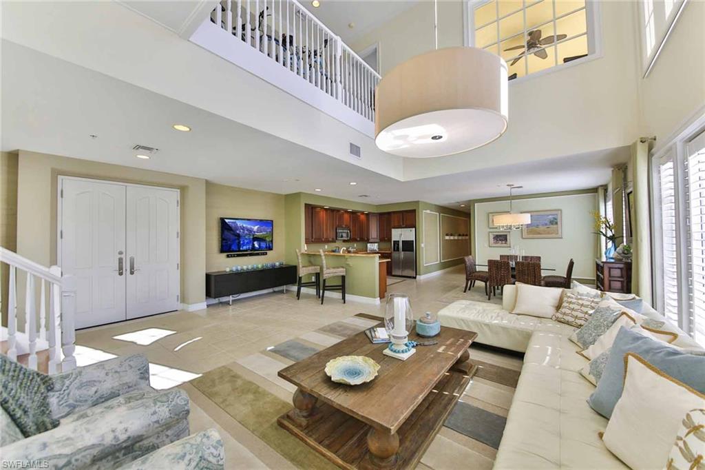 600 5th Avenue South, Unit A212 Naples, FL 34102 - Photo 2 of 21 a living room with furniture and a flat screen tv