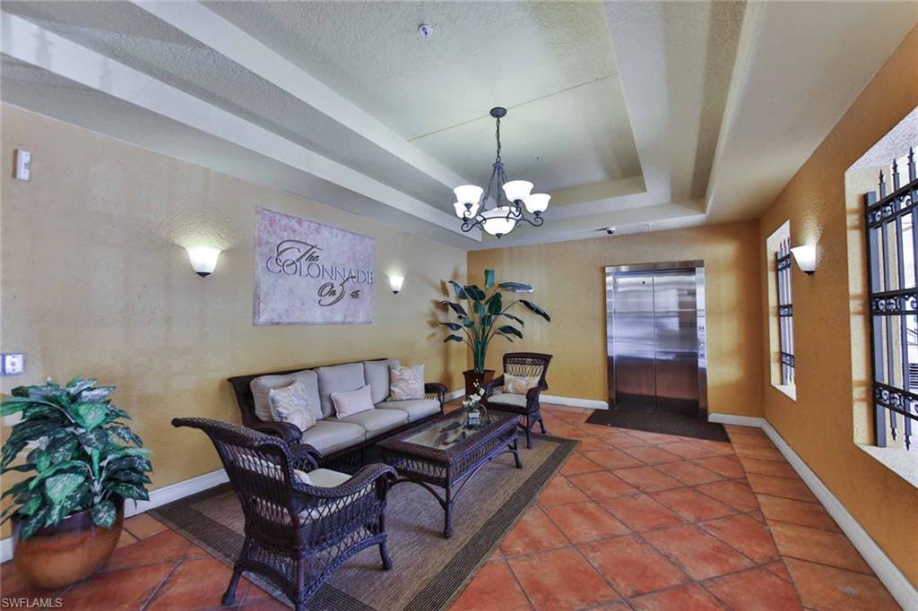 600 5th Avenue South, Unit A212 Naples, FL 34102 - Photo 21 of 21 a living room with furniture and a chandelier