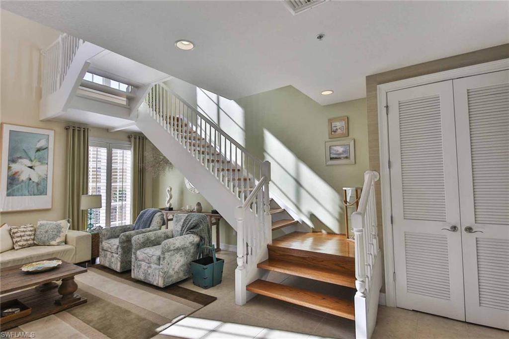 600 5th Avenue South, Unit A212 Naples, FL 34102 - Photo 8 of 21 a living room with furniture and stairs