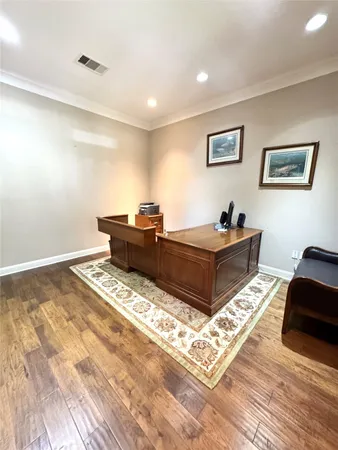 a living room with hard wood flooring and a couch