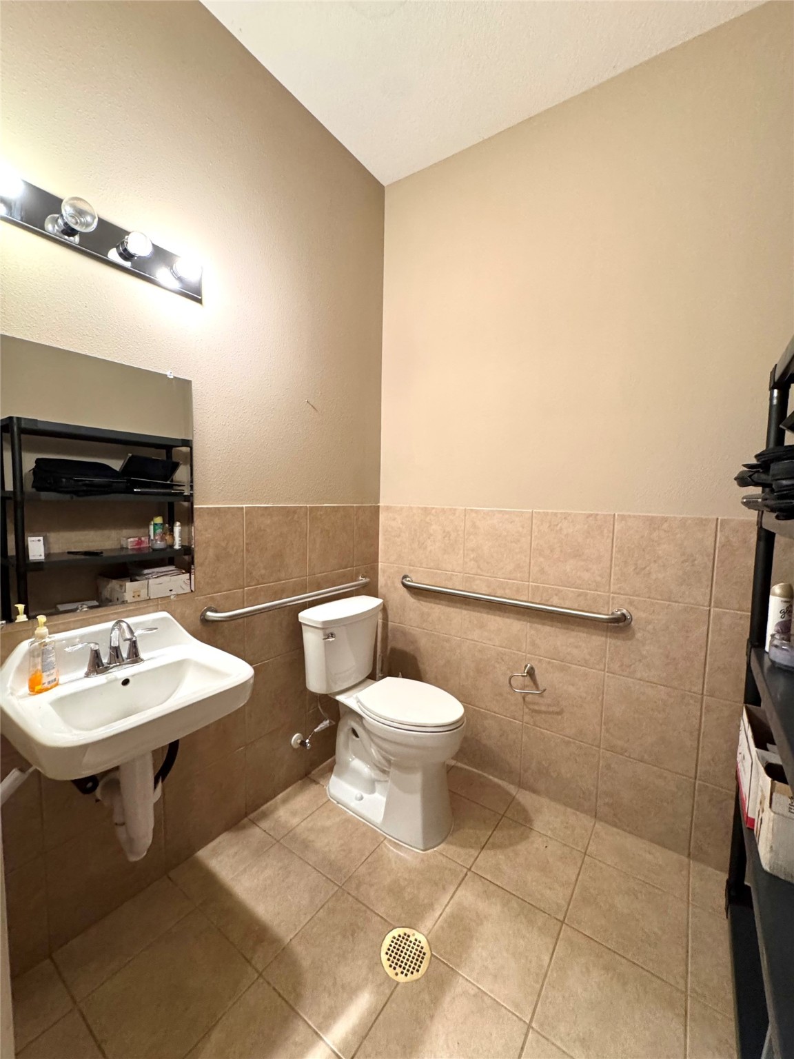 4501 Cartwright Road, Unit 203 Missouri City, TX 77459 - Photo 5 of 11 a bathroom with a toilet a sink and a mirror