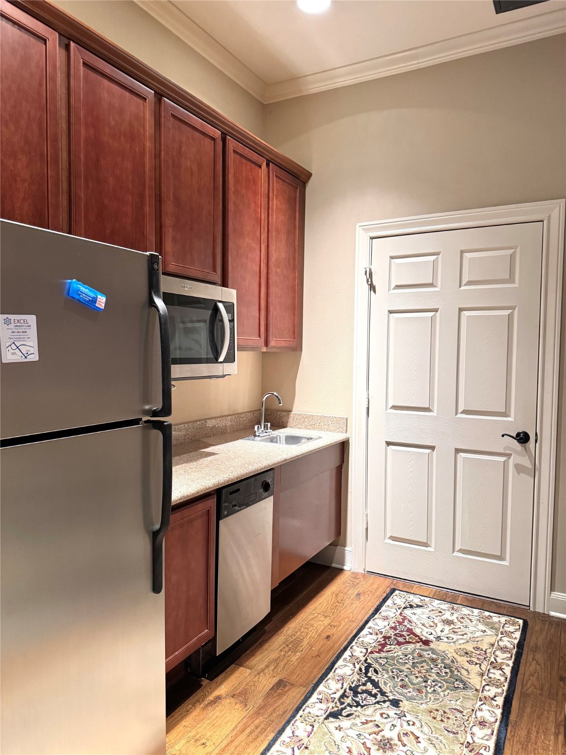 4501 Cartwright Road, Unit 203 Missouri City, TX 77459 - Photo 6 of 11 a kitchen with a refrigerator sink and cabinets