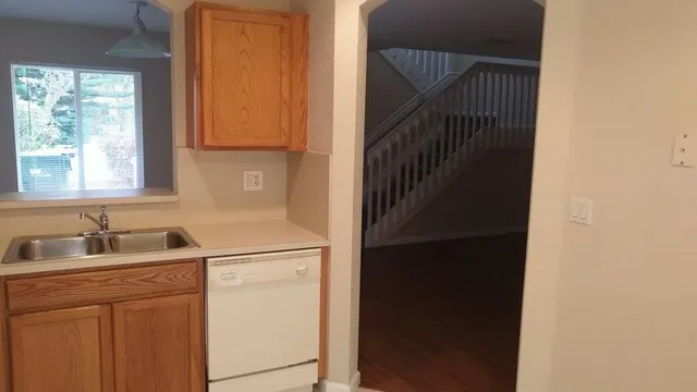 a kitchen with a sink and a window