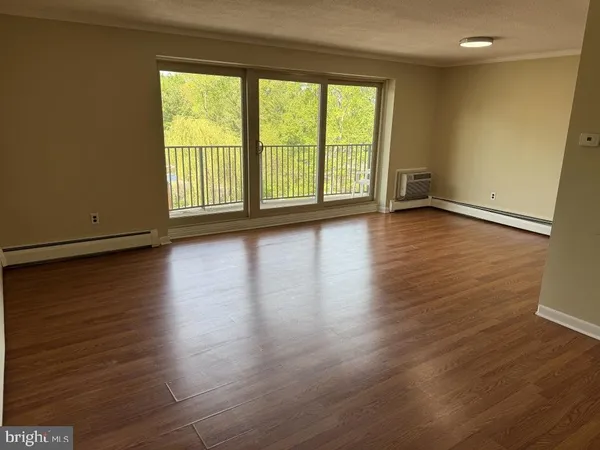 a view of a room with wooden floor and window