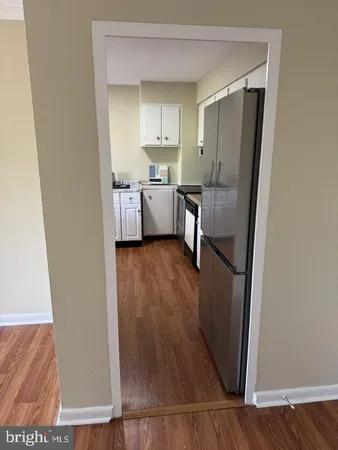 a view of a kitchen from the hallway