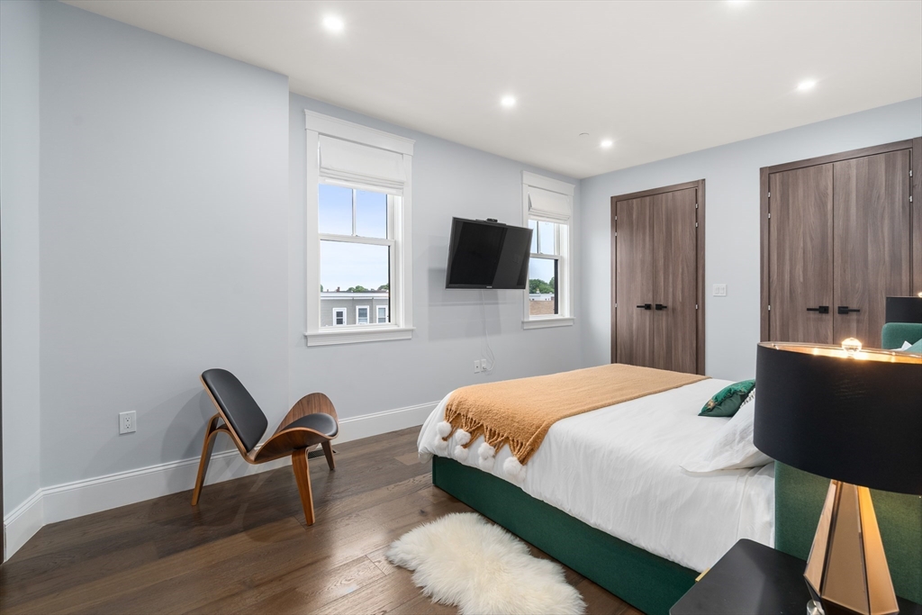 32 Pearl Street, Unit 4 Boston, MA 02125 - Photo 19 of 35 a bedroom with a bed and a television