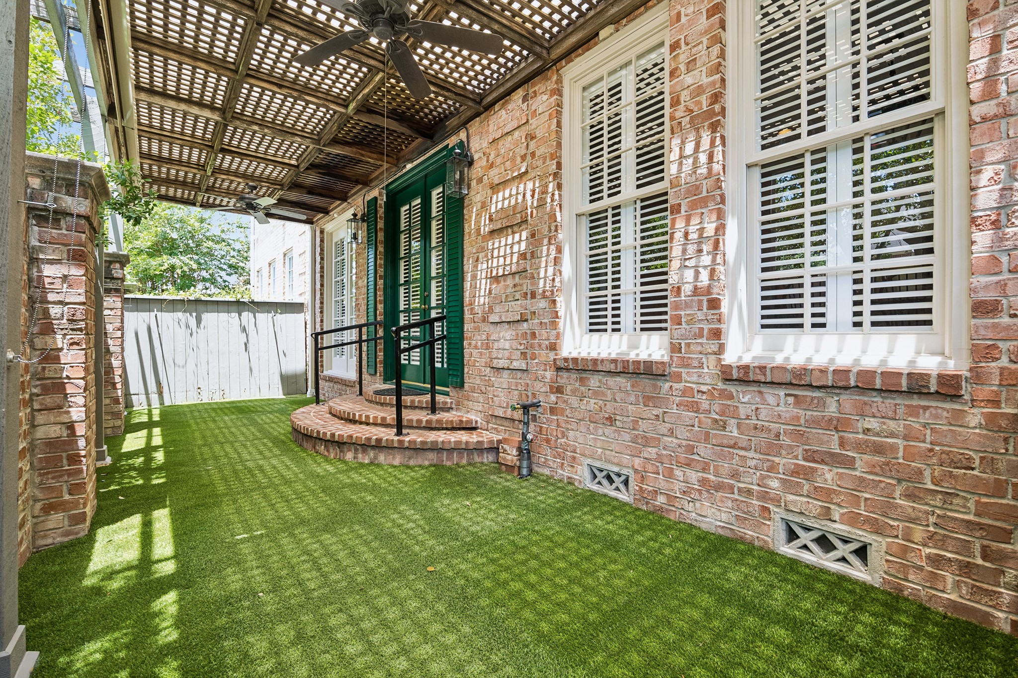 6022 Burgoyne Road Houston, TX 77057 - Photo 25 of 30 Covered courtyard with lattice overhead detail, creating a shaded setting for relaxing or entertaining outdoors.