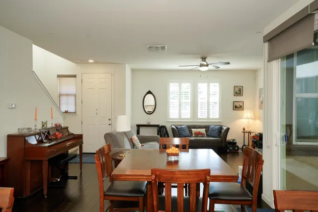 a view of a a dining room with furniture window and wooden floor