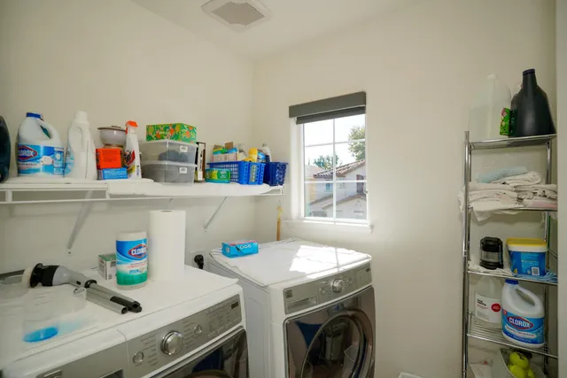 a bedroom with a bed chair and a window