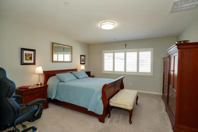 a bedroom with a bed a desk and chair