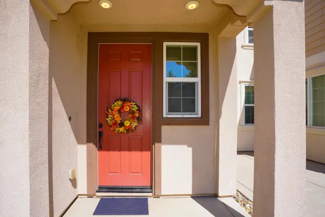hallway with wooden door and furniture