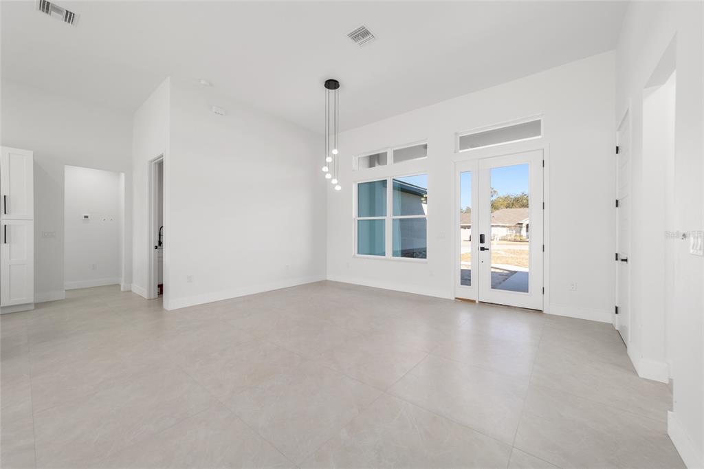 9580 Southwest 44th Avenue Ocala, FL 34476 - Photo 11 of 55 an empty room with chandelier fan and windows