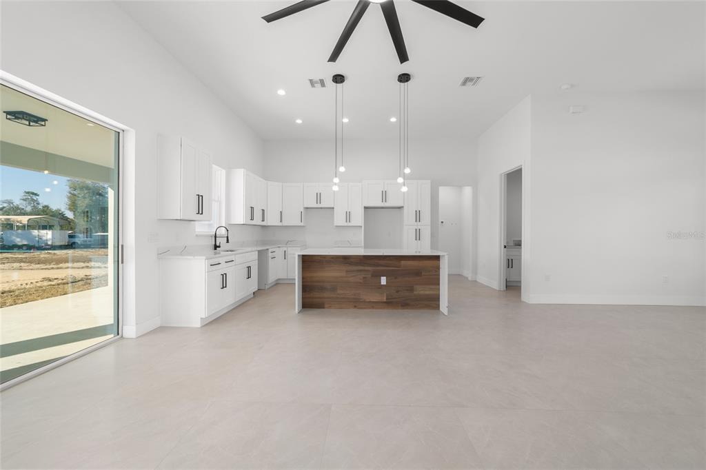 9580 Southwest 44th Avenue Ocala, FL 34476 - Photo 18 of 55 a large white kitchen with a large window cabinets and stainless steel appliances