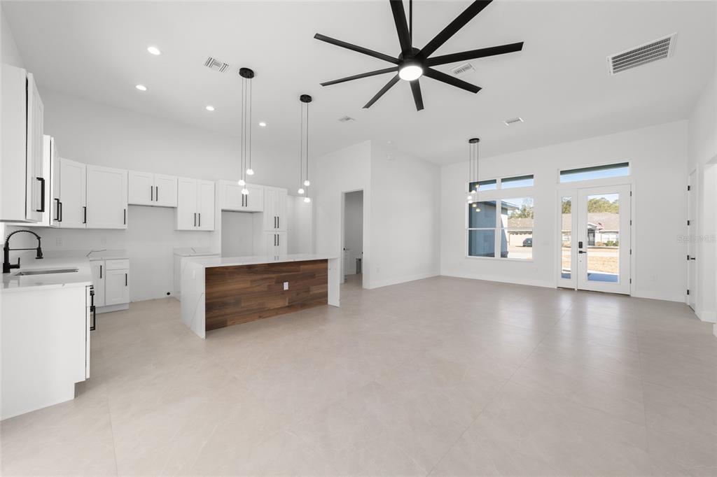 9580 Southwest 44th Avenue Ocala, FL 34476 - Photo 19 of 55 a large white kitchen with center island and stainless steel appliances