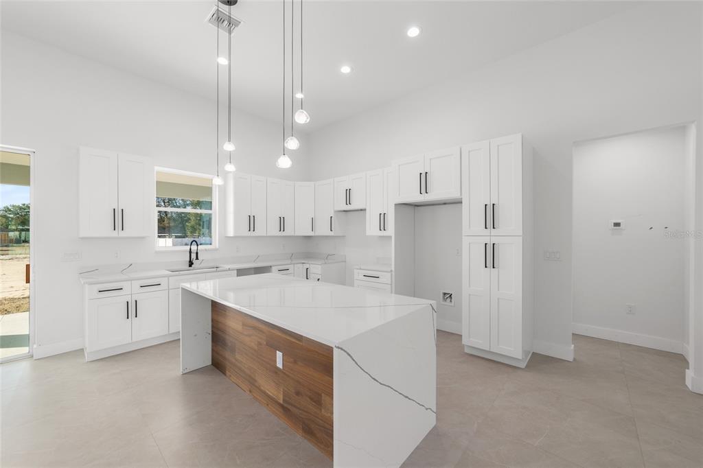 9580 Southwest 44th Avenue Ocala, FL 34476 - Photo 23 of 55 a kitchen with white cabinets and white appliances