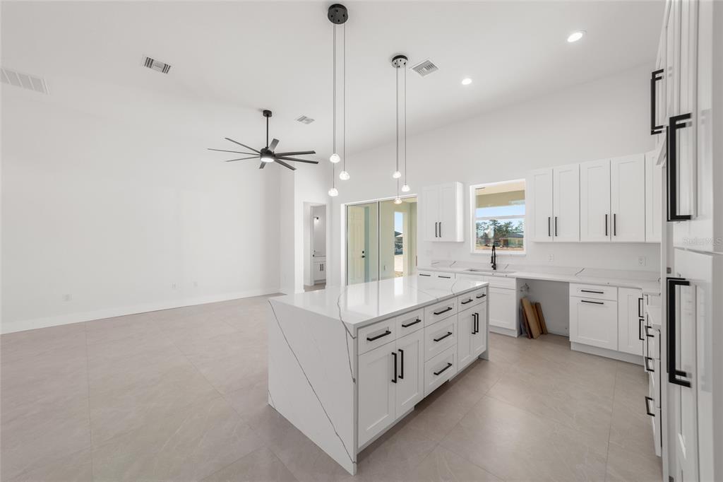 9580 Southwest 44th Avenue Ocala, FL 34476 - Photo 25 of 55 a large kitchen with a lot of counter space and wooden floor
