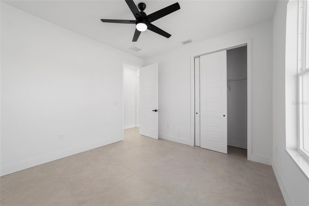 9580 Southwest 44th Avenue Ocala, FL 34476 - Photo 43 of 55 an empty room with windows and fan