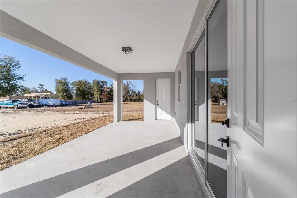9580 Southwest 44th Avenue Ocala, FL 34476 - Photo 49 of 55 a bedroom with a bed and a large window with outer view