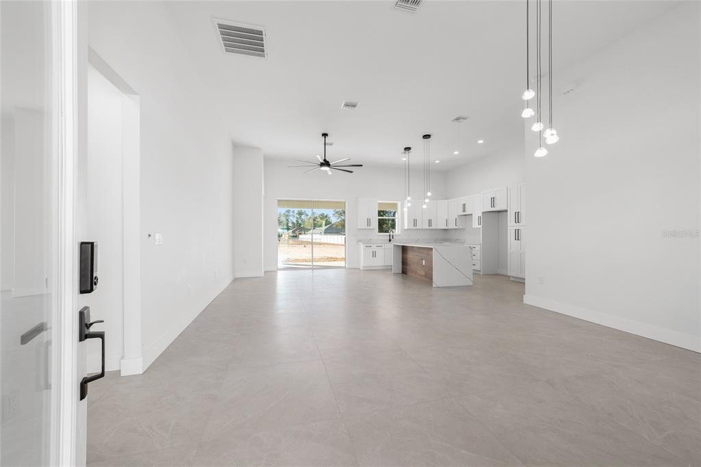 9580 Southwest 44th Avenue Ocala, FL 34476 - Photo 5 of 55 a view of a living room hardwood floor and a kitchen